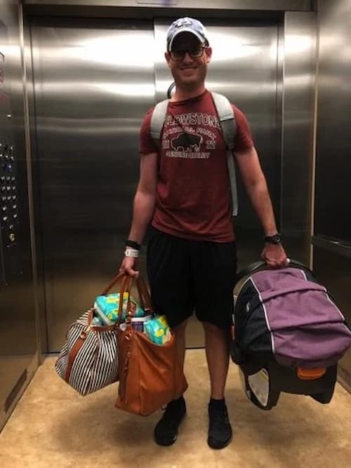 Jesse holding bags of baby clothing